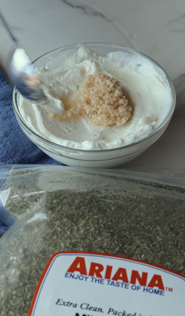 a garlicky yogurt mix with dried mint over it